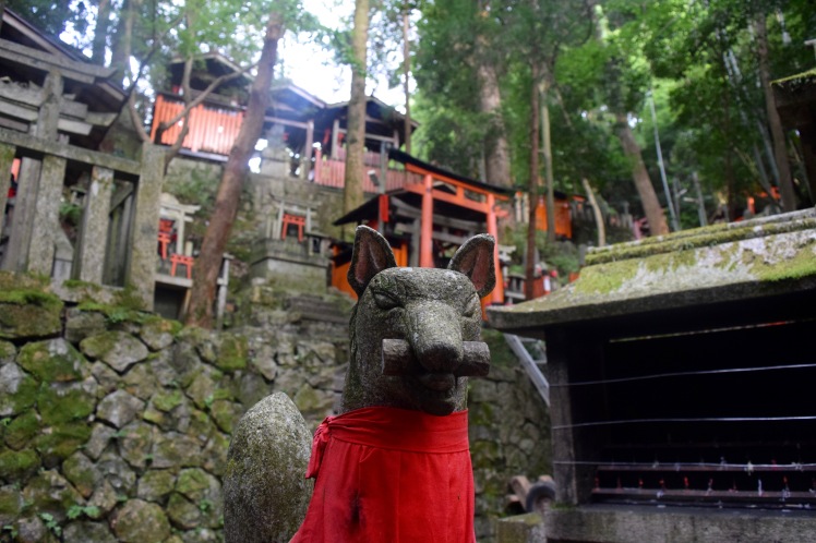 A stone fox statue of the kami Inari found all over the shrine. | Photo by Alexandra Pamias